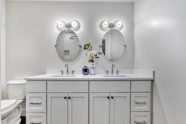 full bath featuring double vanity, toilet, and a sink