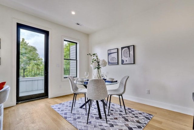 dining room featuring light wood-type flooring, visible vents, baseboards, and recessed lighting