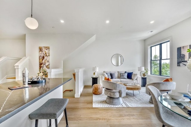 living area featuring recessed lighting, light wood-style floors, and baseboards