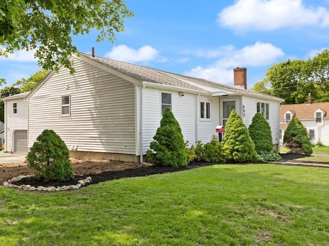 651 S Main St, Randolph, MA 02368 - view of property exterior with a chimney, a yard, and a garage