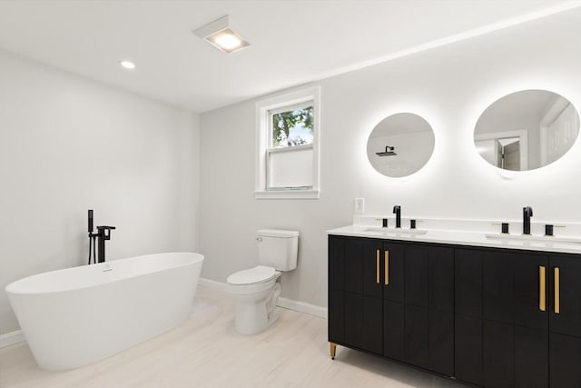 651 S Main St, Randolph, MA 02368 - full bath with double vanity, a freestanding bath, baseboards, and toilet