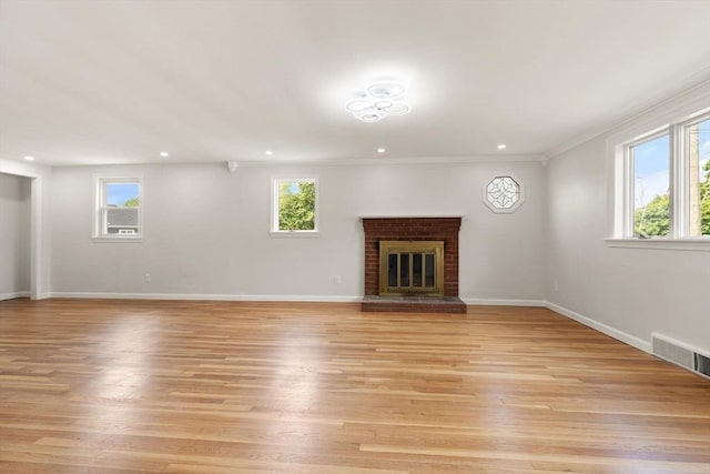 651 S Main St, Randolph, MA 02368 - unfurnished living room with plenty of natural light, light wood-type flooring, a fireplace, recessed lighting, and baseboards