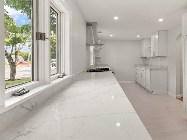 651 S Main St, Randolph, MA 02368 - kitchen featuring island exhaust hood, plenty of natural light, light stone countertops, and recessed lighting
