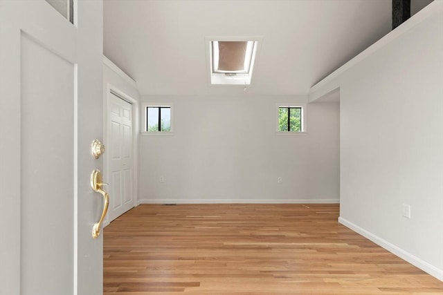 651 S Main St, Randolph, MA 02368 - empty room featuring light wood-style flooring, baseboards, and vaulted ceiling