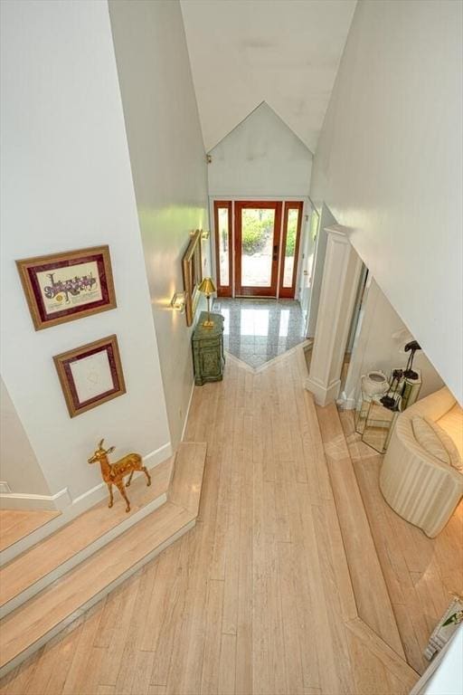 244 Salem End Rd, Framingham, MA 01702 - hallway with high vaulted ceiling, wood finished floors, and baseboards