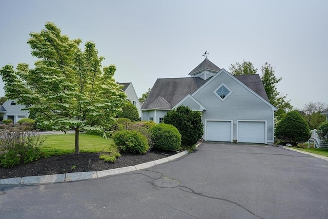 244 Salem End Rd, Framingham, MA 01702 - view of home's exterior with driveway and a garage