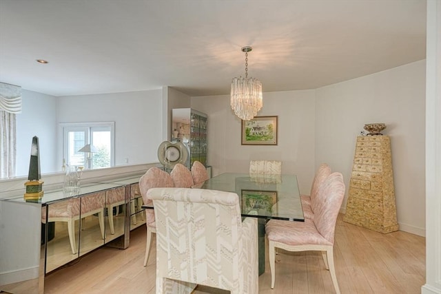 244 Salem End Rd, Framingham, MA 01702 - dining area with a chandelier, light wood finished floors, and baseboards