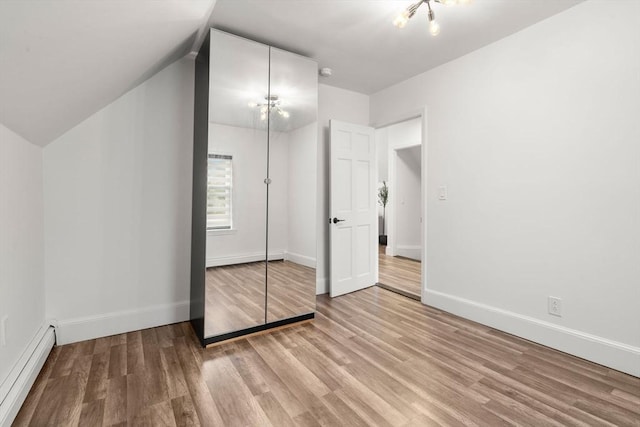 20 Pleasant View Ave, Everett, MA 02149 - unfurnished bedroom with a baseboard radiator, light wood-style floors, lofted ceiling, and a closet