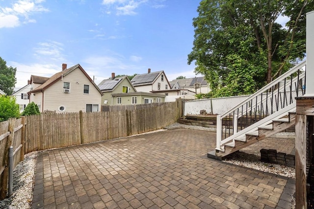 20 Pleasant View Ave, Everett, MA 02149 - fenced backyard featuring a patio area, stairway, and a residential view
