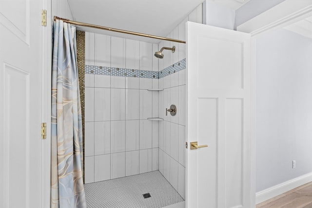 bathroom featuring hardwood / wood-style flooring and a shower with shower curtain