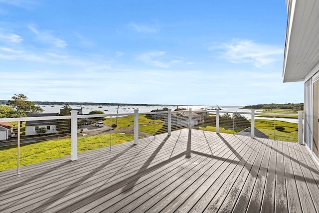 wooden terrace with a lawn and a water view