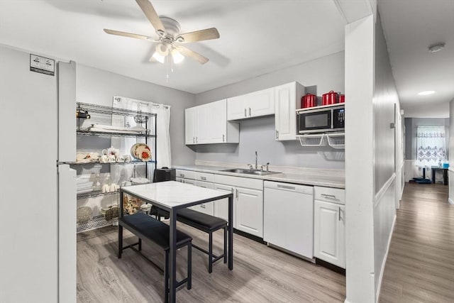 52 Adams St, Taunton, MA 02780 - kitchen featuring white appliances, a sink, a ceiling fan, light countertops, and white cabinetry