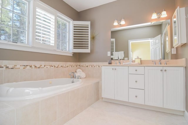 full bathroom with tile patterned floors, double vanity, a sink, and a bath