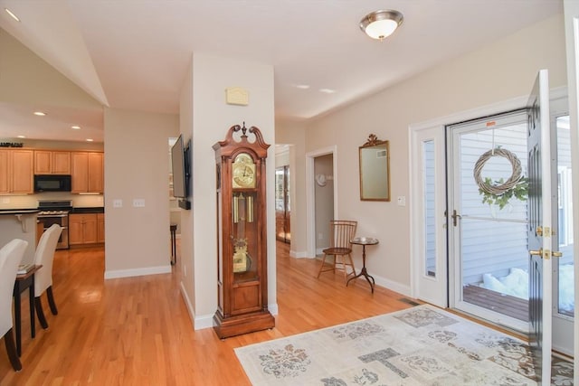 entrance foyer featuring light wood finished floors, visible vents, and baseboards