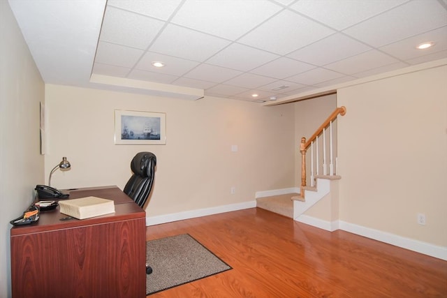 office with recessed lighting, a drop ceiling, baseboards, and wood finished floors