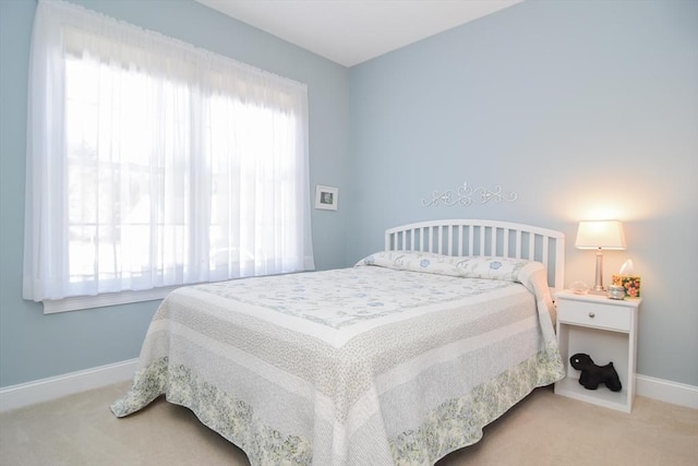 bedroom featuring carpet flooring and baseboards