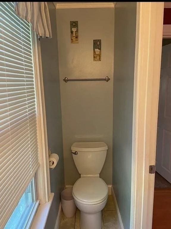 bathroom featuring ornamental molding, tile patterned floors, and toilet