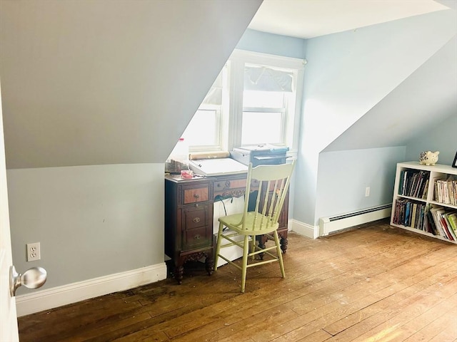 office area with lofted ceiling, a baseboard heating unit, and hardwood / wood-style floors