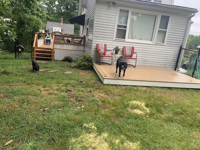 exterior space featuring a deck and a lawn