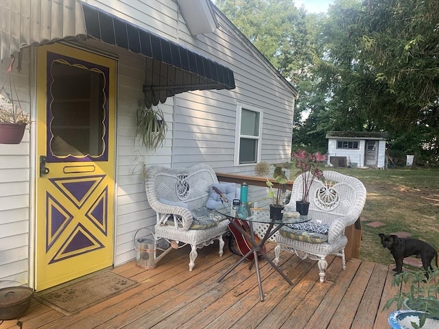 wooden terrace with a shed