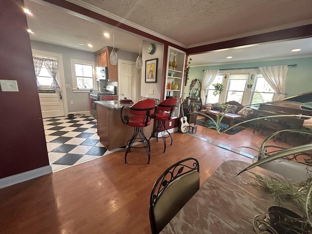 living room featuring plenty of natural light, ornamental molding, and a textured ceiling