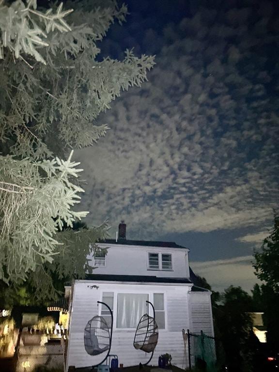 view of back house at dusk