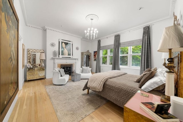 258-260 Beacon St Unit 4, Boston, MA 02116 - bedroom featuring a chandelier, ornamental molding, light wood finished floors, and a fireplace