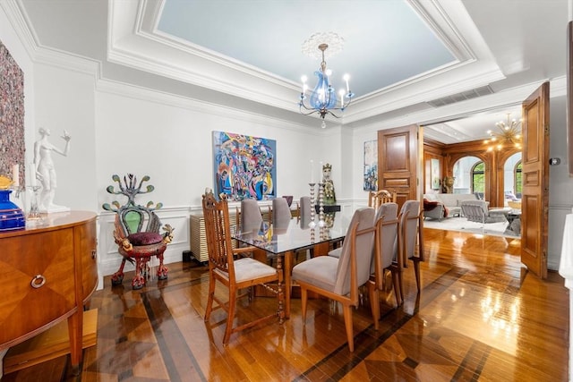 258-260 Beacon St Unit 4, Boston, MA 02116 - dining space with a chandelier, a tray ceiling, a decorative wall, crown molding, and wood-type flooring