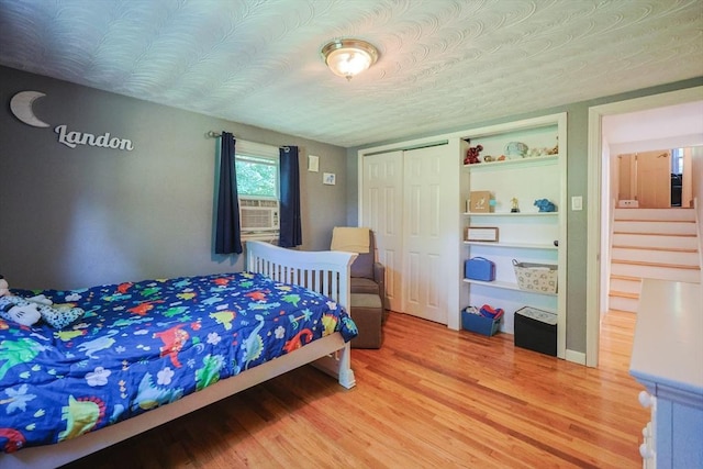 161 N Worcester St, Norton, MA 02766 - bedroom with light wood-style flooring, a closet, and cooling unit