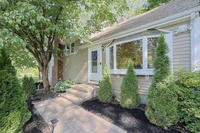 161 N Worcester St, Norton, MA 02766 - view of exterior entry with a chimney