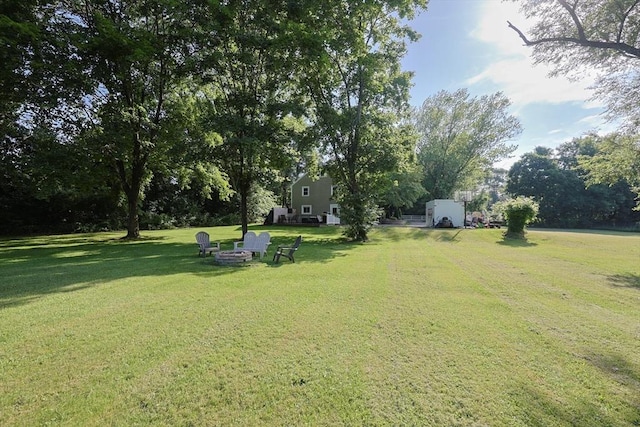 161 N Worcester St, Norton, MA 02766 - view of grassy yard with a fire pit and view of scattered trees