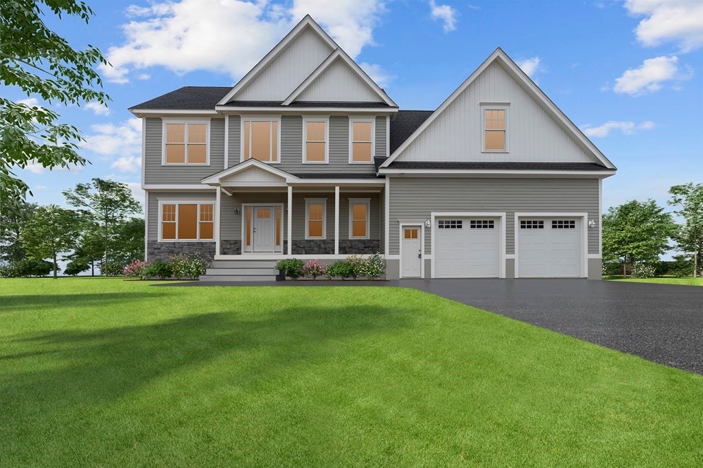 view of front of property with a front yard and a garage