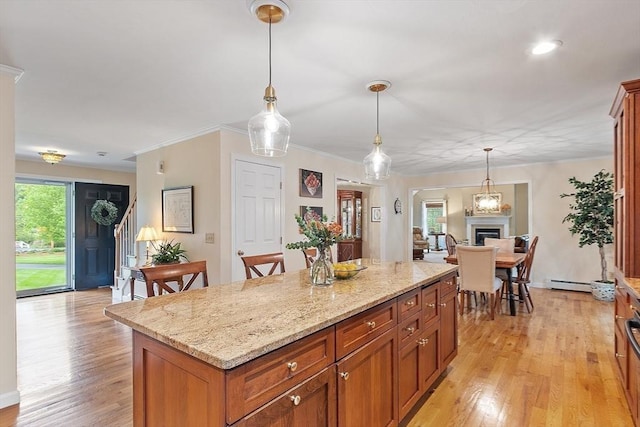 86 S Cross Rd, Haverhill, MA 01835 - kitchen with light wood-style floors, a center island, decorative light fixtures, light stone countertops, and ornamental molding
