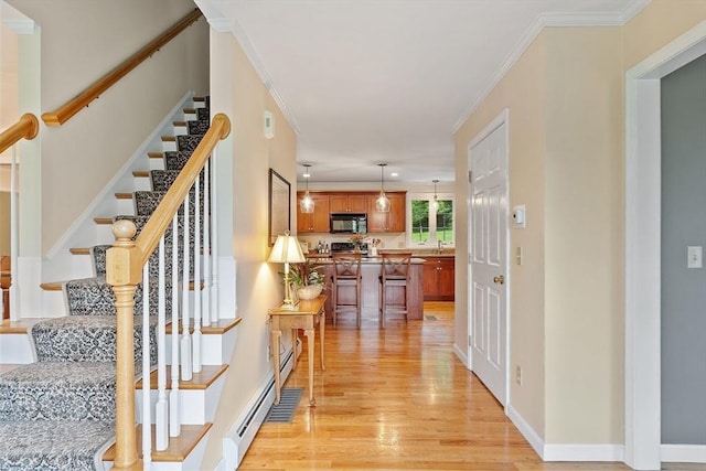 86 S Cross Rd, Haverhill, MA 01835 - hallway featuring light wood finished floors, stairway, ornamental molding, baseboards, and a baseboard radiator