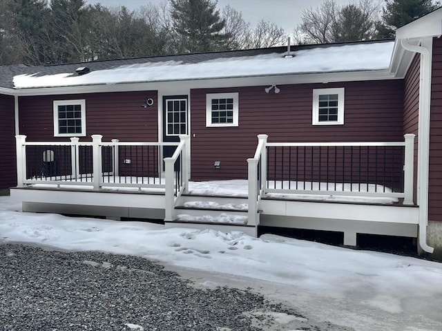 snow covered property with a deck