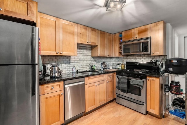 267 Lexington St Unit 1, Boston, MA 02128 - kitchen with stainless steel appliances, tasteful backsplash, light wood-style flooring, and dark stone countertops