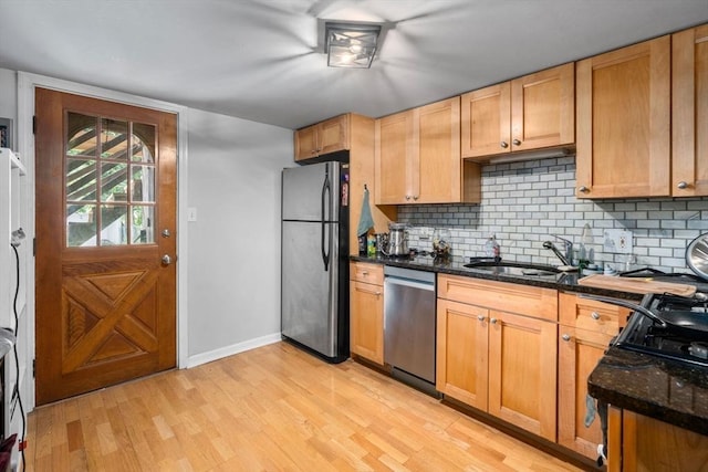 267 Lexington St Unit 1, Boston, MA 02128 - kitchen with appliances with stainless steel finishes, light wood finished floors, backsplash, and dark stone counters