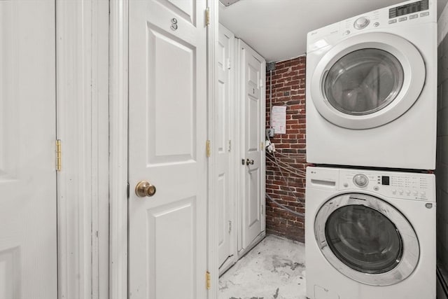 267 Lexington St Unit 1, Boston, MA 02128 - laundry room with brick wall and estacked washer and dryer