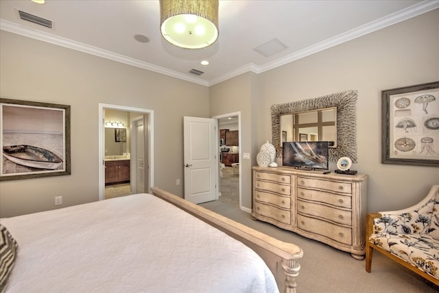 bedroom with ornamental molding, connected bathroom, and carpet