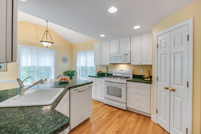 20 Crestview Cir, Barnstable, MA 02632 - kitchen with white appliances, a sink, white cabinets, vaulted ceiling, and pendant lighting