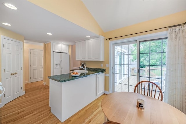 20 Crestview Cir, Barnstable, MA 02632 - kitchen with white refrigerator with ice dispenser, white cabinets, lofted ceiling, light wood-style flooring, and a peninsula