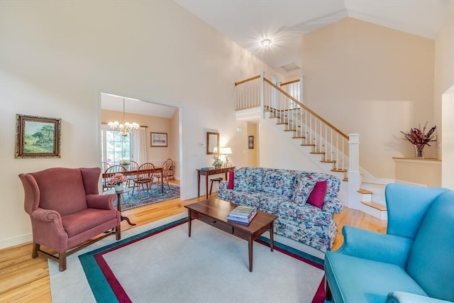 20 Crestview Cir, Barnstable, MA 02632 - living room with wood finished floors, high vaulted ceiling, a chandelier, stairway, and baseboards