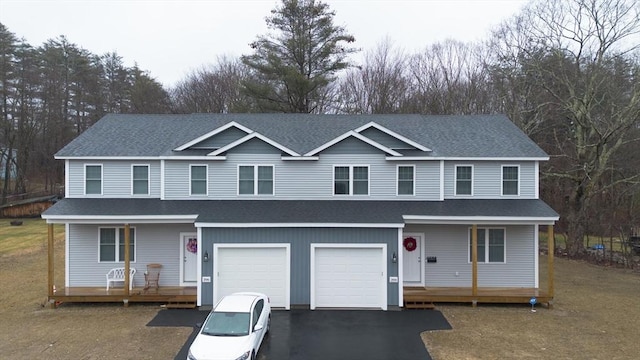 view of front of property featuring covered porch and a garage