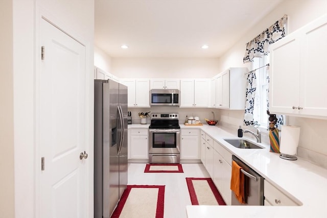 kitchen with white cabinetry, sink, and appliances with stainless steel finishes