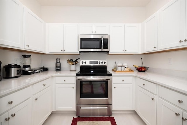 kitchen featuring white cabinets and appliances with stainless steel finishes