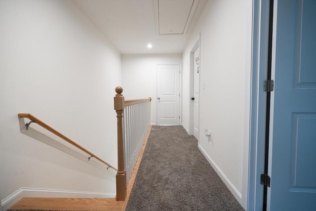 hallway featuring dark carpet