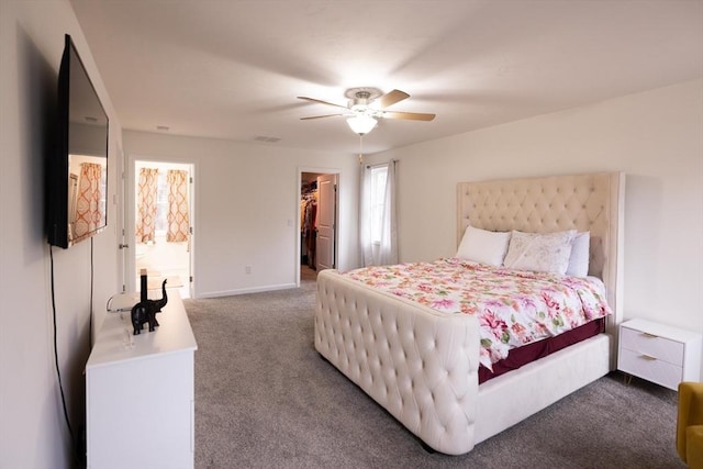 carpeted bedroom featuring a closet, a spacious closet, and ceiling fan