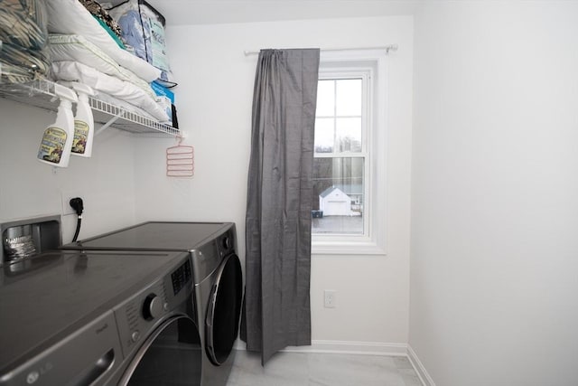 laundry room featuring light tile patterned floors and washing machine and clothes dryer