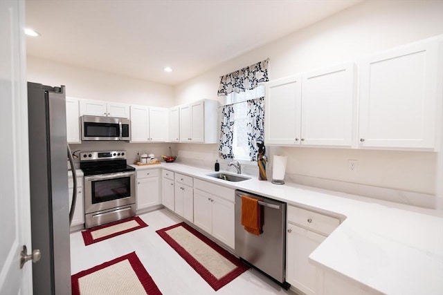 kitchen with white cabinetry, sink, and stainless steel appliances