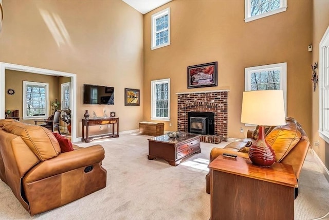 living room featuring a towering ceiling, light colored carpet, and baseboards
